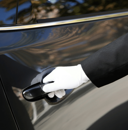 man with white glove opening car door